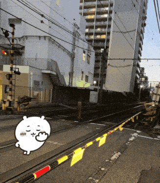 a cartoon drawing of a bear is on the train tracks