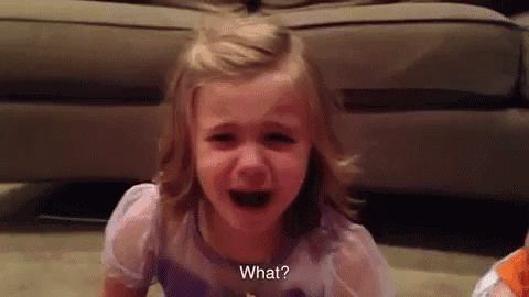 a little girl is crying in front of a couch and asking what .