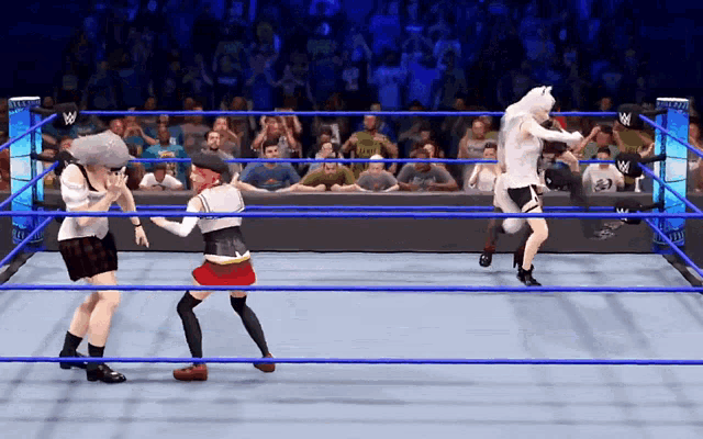 wrestlers in a wrestling ring with a crowd watching and a sign that says w on it