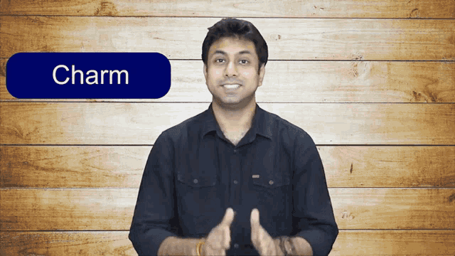 a man stands in front of a wooden wall with a blue button that says charm on it