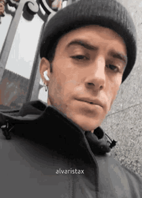 a close up of a man wearing a beanie and a jacket .