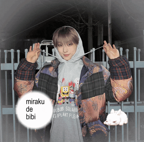 a person wearing a spongebob squarepants t-shirt with miraku de bibi written on the bottom