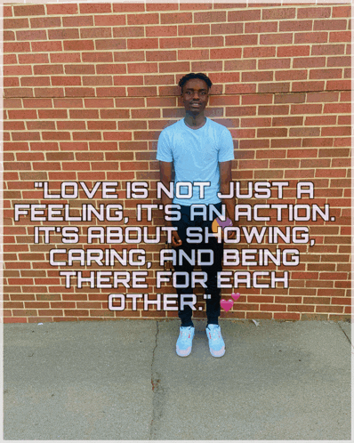 a man is standing in front of a brick wall with a quote that says love is not just a feeling it 's an action
