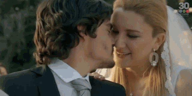a bride and groom kissing with the number 30 on the bottom
