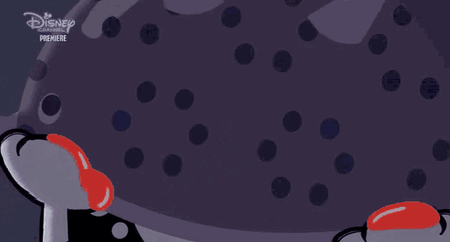 a dalmatian dog is wearing a purple hat and has a surprised look on its face .