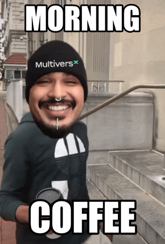 a man wearing a hat that says multivers on it is holding a cup of coffee