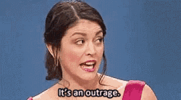a woman in a pink dress is talking and says `` it 's an outrage . ''