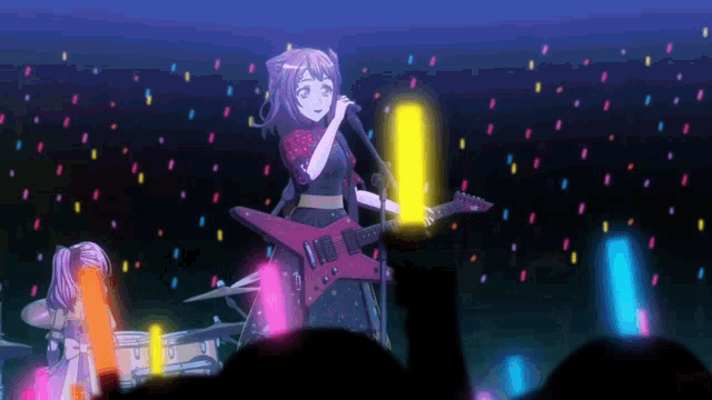 a girl is playing a guitar and singing into a microphone
