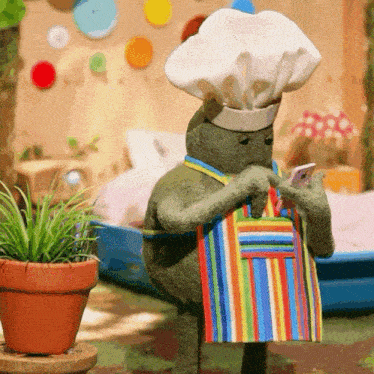 a stuffed animal wearing a chef 's hat and apron