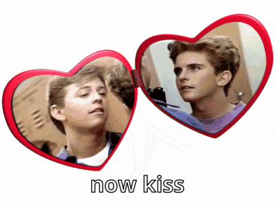 a couple of heart shaped mirrors with the words now kiss below them