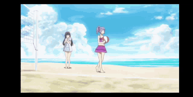 two girls are standing on a beach with volleyball nets in the background