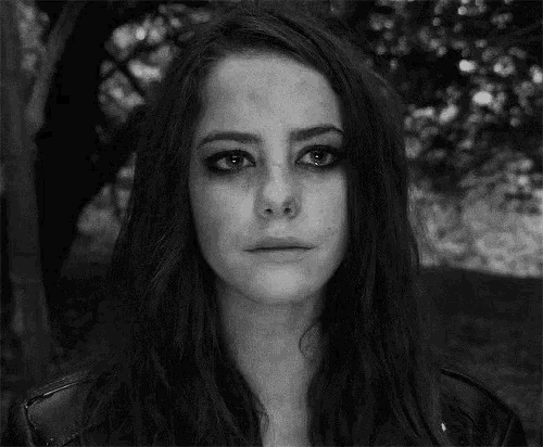 a black and white photo of a woman with a crying face .