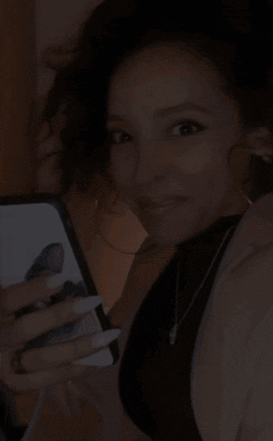 a woman holding a cell phone with the words be serious written below her