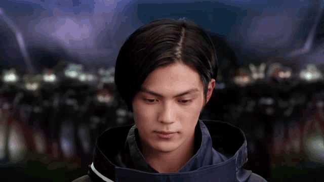 a man in a black jacket looks down at something