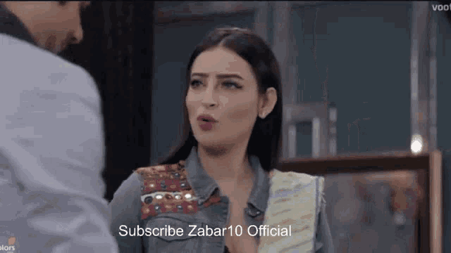 a man and a woman are standing next to each other with the words subscribe zabar10 official in the corner