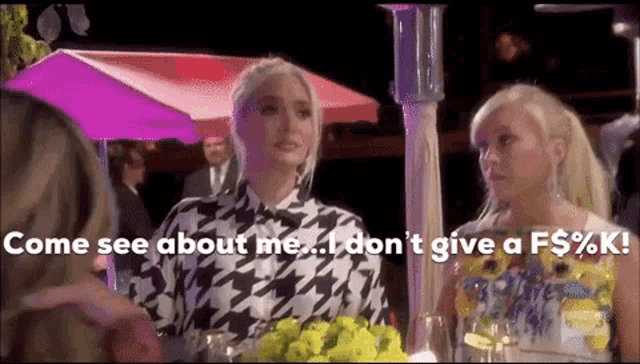 two women are sitting at a table and one of them says come see about me i don t give a f $ % k !