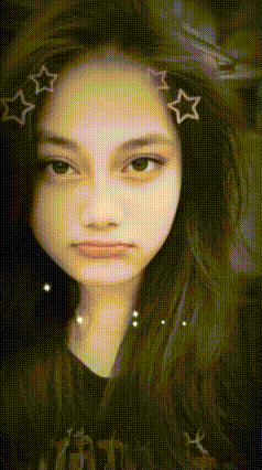 a girl with stars in her hair is making a funny face .
