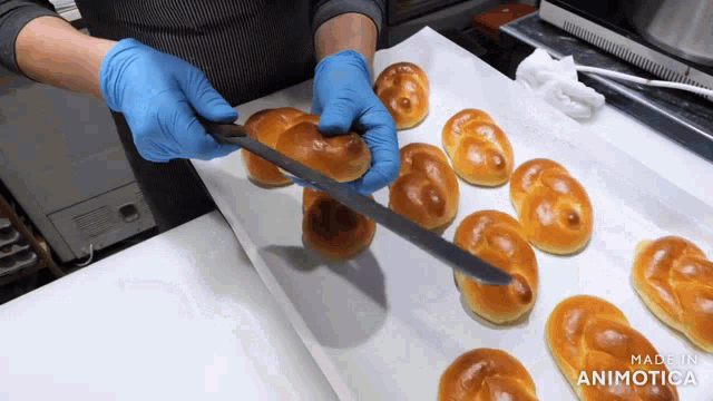 a person is cutting a bun with a knife and the words made in animatica are visible