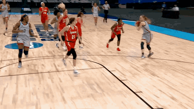 a basketball game is being played on a court that has syracuse written on the floor