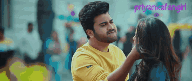 a man in a yellow shirt is touching a woman 's face with the words " priyankafangirl " in the corner