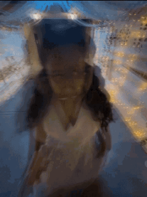 a blurry picture of a girl in a white dress with a blue background