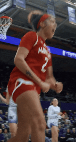 a female basketball player wearing a red jersey with the number 2 on it
