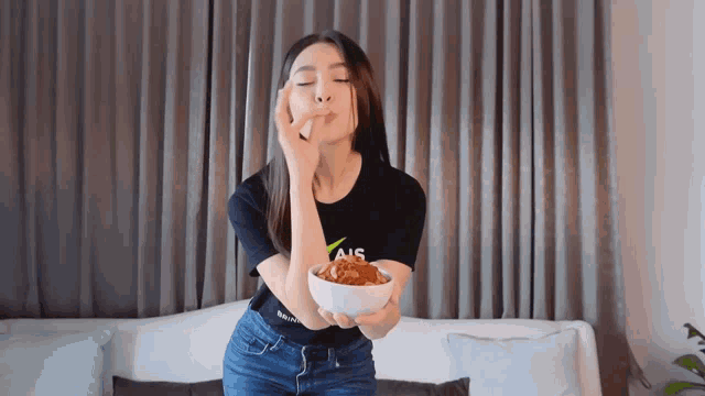 a woman wearing a black shirt that says ais on it