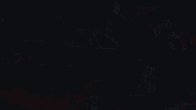 a white car with a red tail light is parked next to a black car