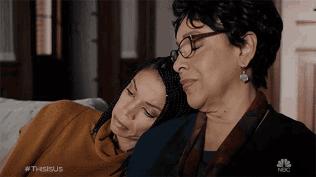 two women are sitting on a couch with the nbc logo in the corner