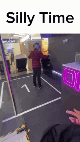 a man wearing a virtual reality headset is standing in a room with the words " silly time " on the bottom