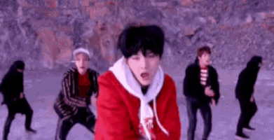 a group of young men are dancing on ice in a video .