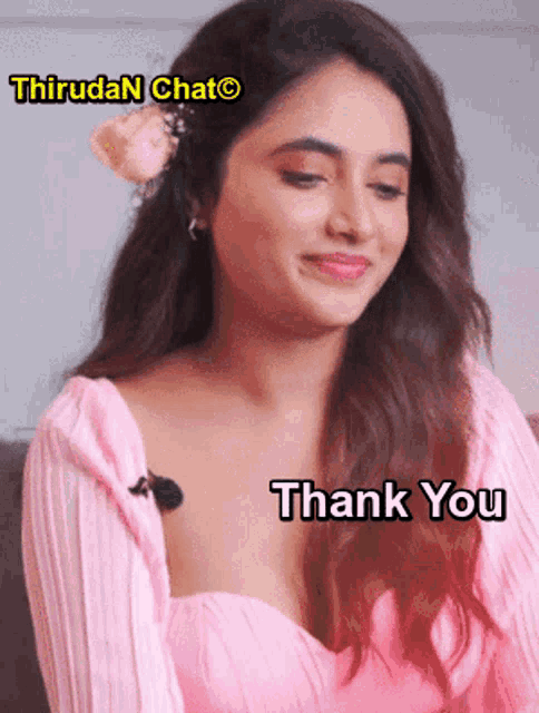 a woman in a pink top with a flower in her hair says " thank you "