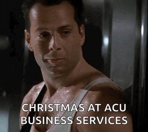 a man in a white tank top is sweating and says christmas at acu business services .
