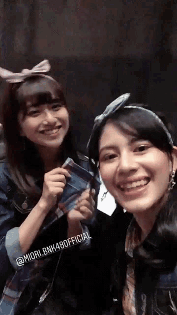 two girls are posing for a picture with the caption " @ miori.bnk480official "