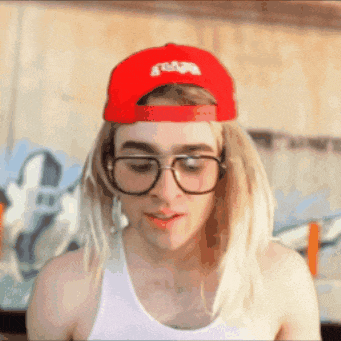 a man wearing glasses and a red hat that says ' snoop dogg ' on it