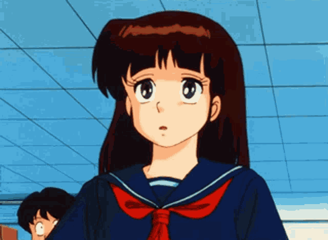 a girl in a sailor suit with a red bow tie