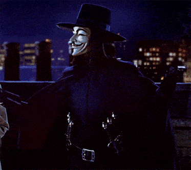 a man in a hat and cape with a mask on