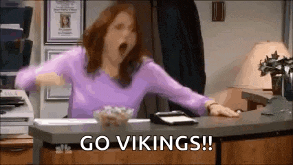 a woman is yawning while sitting at a desk and screaming .