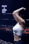 a woman in a white tank top is standing in front of a sign that says have a good day .