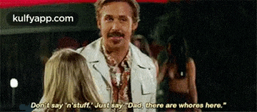 a man with a mustache is talking to a woman in a white suit .