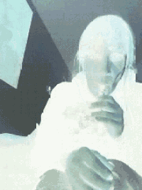 a blurry picture of a woman holding a glass of wine