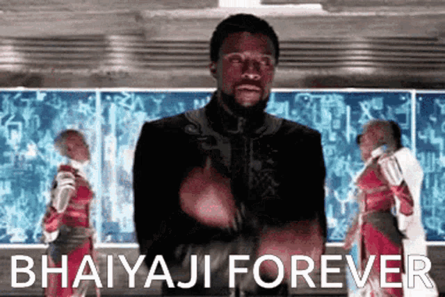 a man is giving a thumbs up in front of a sign that says bhaiyaji forever .