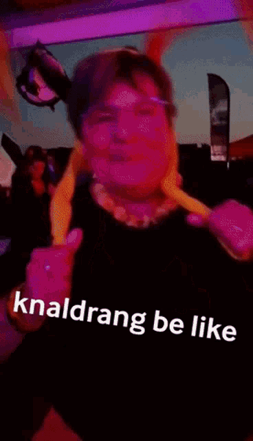 a woman wearing a headband that says knaldrang be like