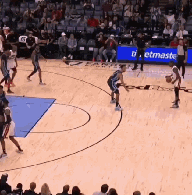 a basketball game is being played in front of a sign that says " ticketmaster "