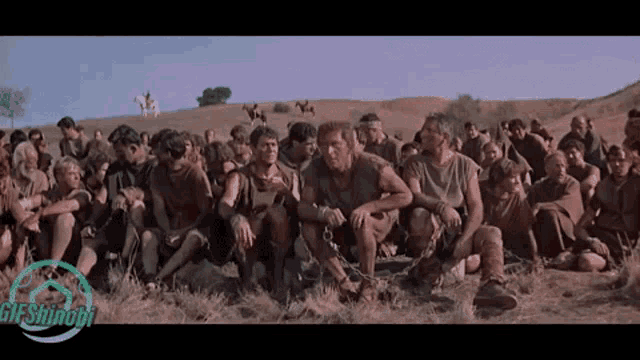 a group of men are chained together in a field with a gif snapshot in the bottom right corner