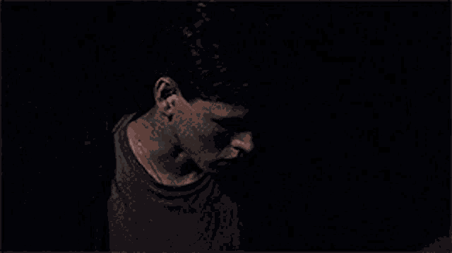 a close up of a man 's face in the dark