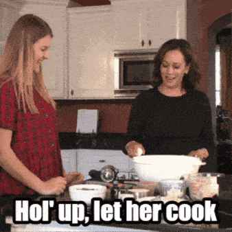 two women cooking in a kitchen with a caption that says " hold up let her cook "