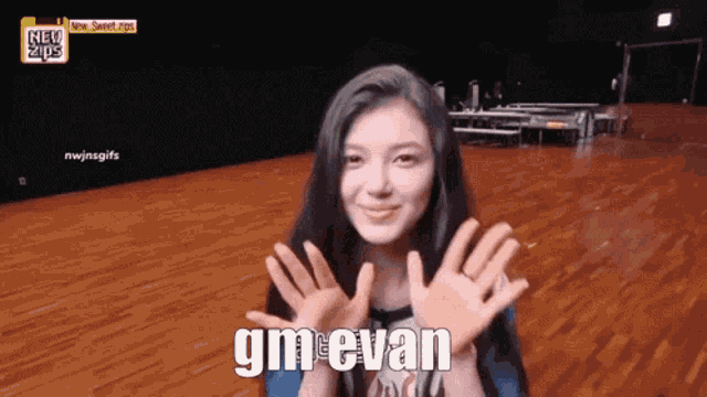 a girl says gmevan with her hands up