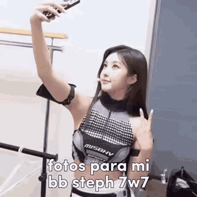 a woman is taking a selfie with her cell phone .