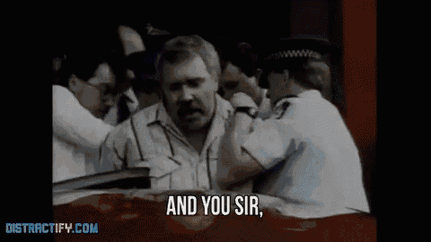 a group of police officers are holding a man in a car and the man is saying and you sir .